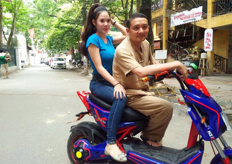 Chiến Thắng tạo dáng cung diễn viên nữ bên xe máy điện Xmen Ngọc Hà Trong một cảnh quay